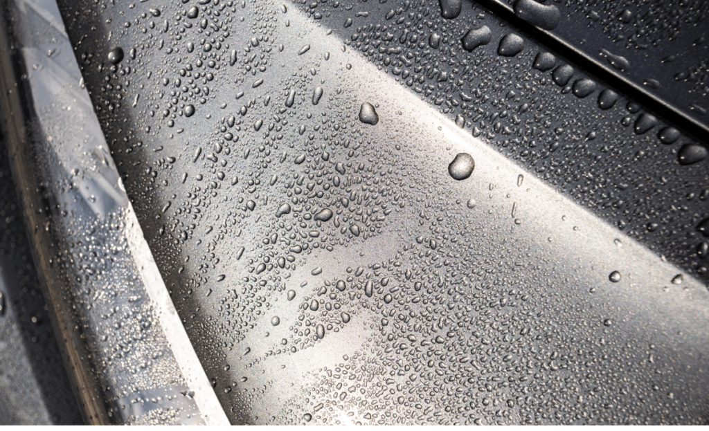 Water beads on a ceramic-coated car surface.