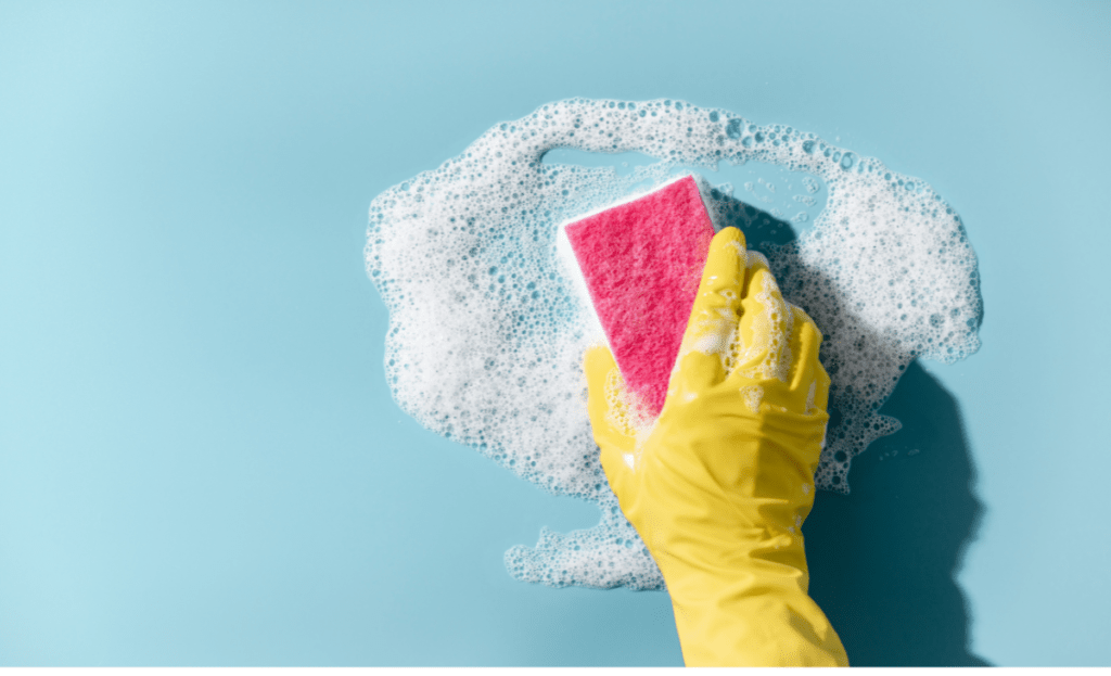 Dish soap and sponge used to remove sticky residue from a countertop.